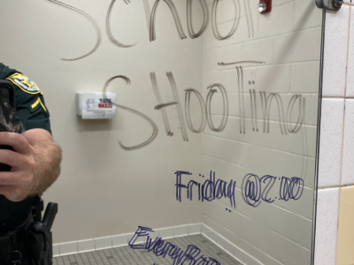 Threatening message in middle school bathroom leads to two arrests
