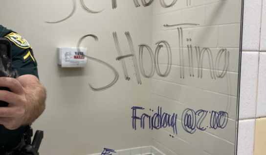 Threatening message in middle school bathroom leads to two arrests